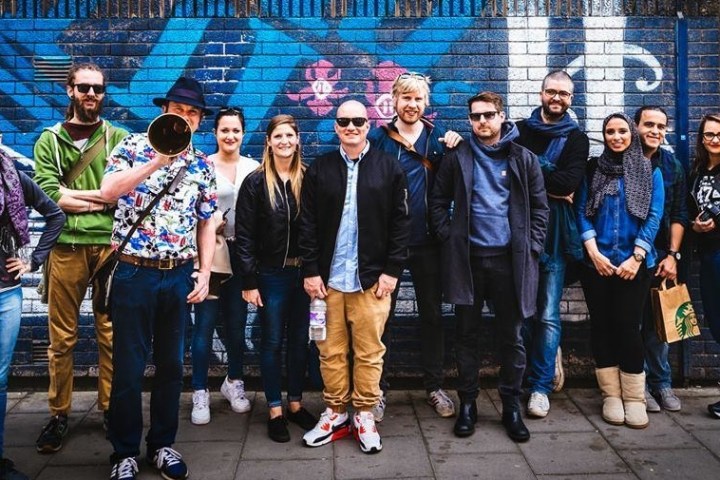 Tour guide posing with a group of guests on Nelson Street in Bristol