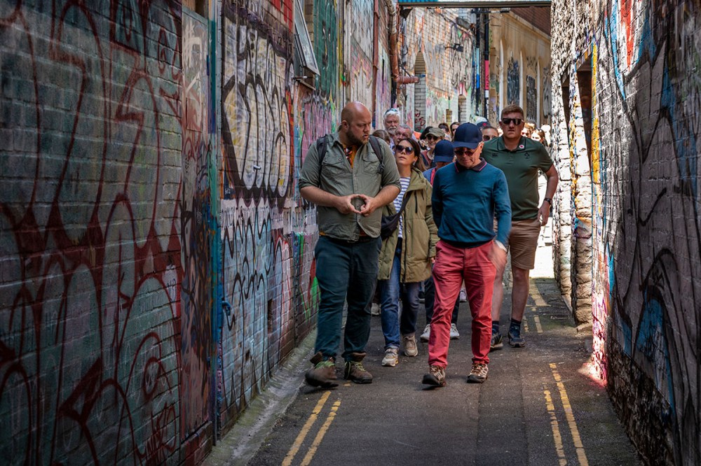 a group of people standing on a sidewalk